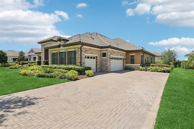 14715 Fishhawk Preserve Dr, Lithia, FL 33547 - view of front of home with stone siding, a garage, decorative driveway, a tiled roof, and a front yard