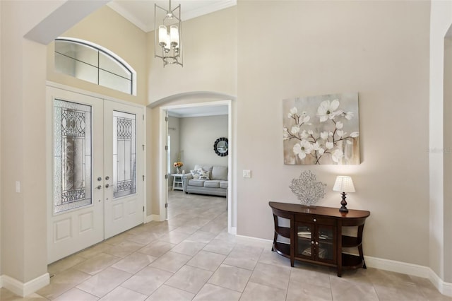 14715 Fishhawk Preserve Dr, Lithia, FL 33547 - foyer entrance with arched walkways, french doors, a towering ceiling, baseboards, and a chandelier