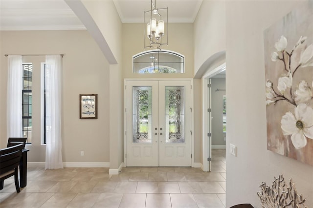 14715 Fishhawk Preserve Dr, Lithia, FL 33547 - entryway with arched walkways, healthy amount of natural light, a chandelier, french doors, and crown molding