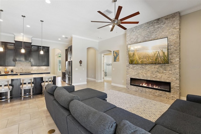 14715 Fishhawk Preserve Dr, Lithia, FL 33547 - living room featuring arched walkways, ceiling fan, light tile patterned floors, recessed lighting, and ornamental molding