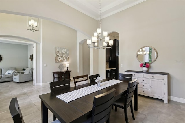 14715 Fishhawk Preserve Dr, Lithia, FL 33547 - dining area with arched walkways, a chandelier, light tile patterned floors, ornamental molding, and baseboards