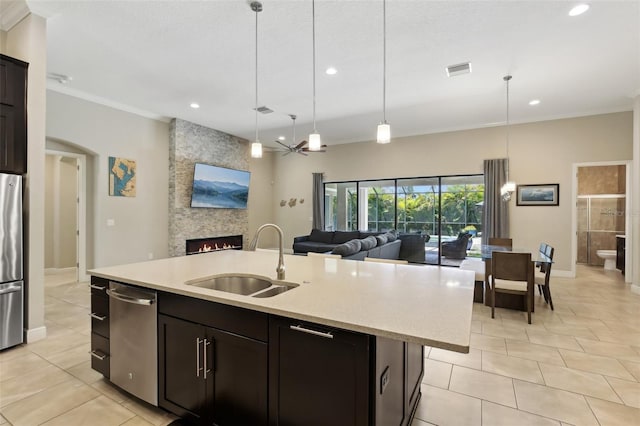 14715 Fishhawk Preserve Dr, Lithia, FL 33547 - kitchen featuring a sink, stainless steel appliances, recessed lighting, open floor plan, and a large fireplace