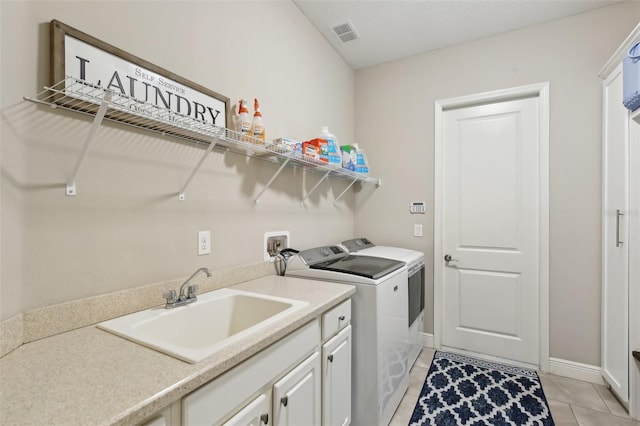 14715 Fishhawk Preserve Dr, Lithia, FL 33547 - washroom featuring washer and clothes dryer, light tile patterned floors, cabinet space, and baseboards