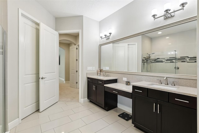 14715 Fishhawk Preserve Dr, Lithia, FL 33547 - full bathroom featuring double vanity, a stall shower, baseboards, and tile patterned flooring