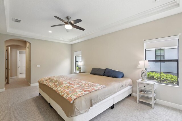 14715 Fishhawk Preserve Dr, Lithia, FL 33547 - bedroom with a raised ceiling, arched walkways, multiple windows, carpet, and ornamental molding