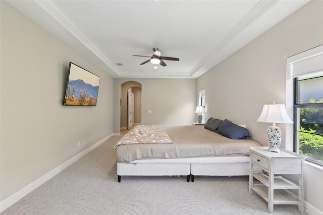 14715 Fishhawk Preserve Dr, Lithia, FL 33547 - bedroom with arched walkways, a tray ceiling, carpet, baseboards, and crown molding