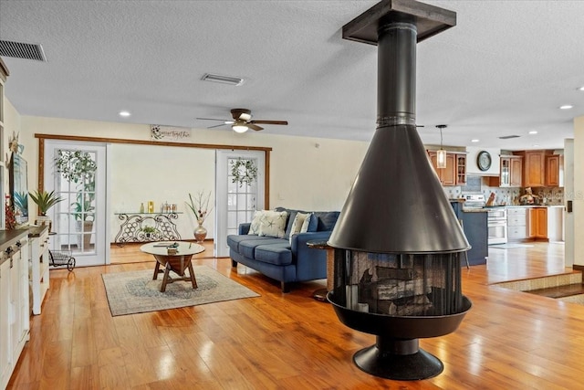 4301 S Lockwood Ridge Rd, Sarasota, FL 34231 - living room with a ceiling fan, light wood-style flooring, a textured ceiling, and recessed lighting
