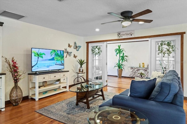 4301 S Lockwood Ridge Rd, Sarasota, FL 34231 - living room featuring wood finished floors, ceiling fan, a textured ceiling, and baseboards