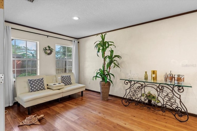 4301 S Lockwood Ridge Rd, Sarasota, FL 34231 - sitting room with ornamental molding, a textured ceiling, wood finished floors, and baseboards