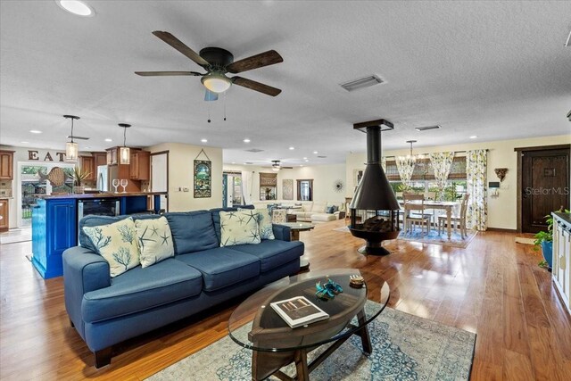 4301 S Lockwood Ridge Rd, Sarasota, FL 34231 - living area with a ceiling fan, wood finished floors, plenty of natural light, recessed lighting, and a textured ceiling