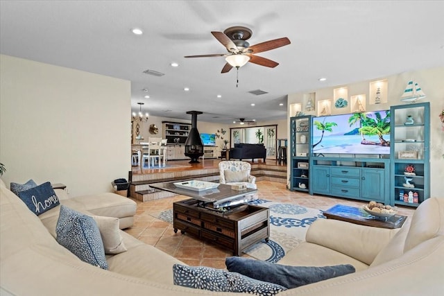 4301 S Lockwood Ridge Rd, Sarasota, FL 34231 - living area with a wood stove, a ceiling fan, recessed lighting, and light tile patterned floors
