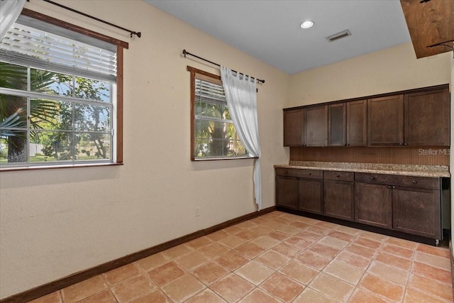 4301 S Lockwood Ridge Rd, Sarasota, FL 34231 - kitchen featuring dark brown cabinets, baseboards, light countertops, and recessed lighting