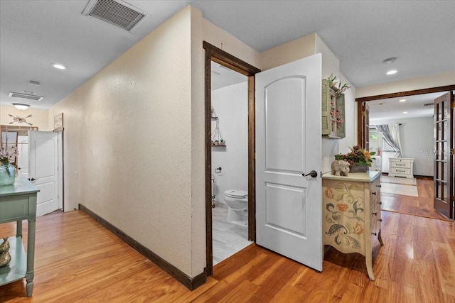 4301 S Lockwood Ridge Rd, Sarasota, FL 34231 - hall with light wood finished floors, a textured wall, baseboards, and recessed lighting