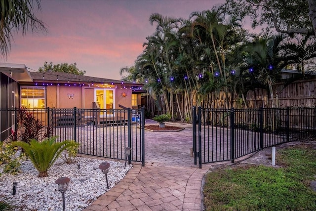 4301 S Lockwood Ridge Rd, Sarasota, FL 34231 - gate at dusk with a patio area