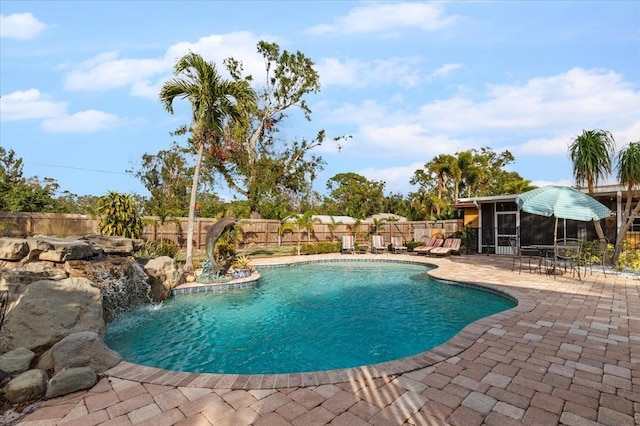 4301 S Lockwood Ridge Rd, Sarasota, FL 34231 - view of swimming pool featuring a patio, a fenced backyard, and a sunroom