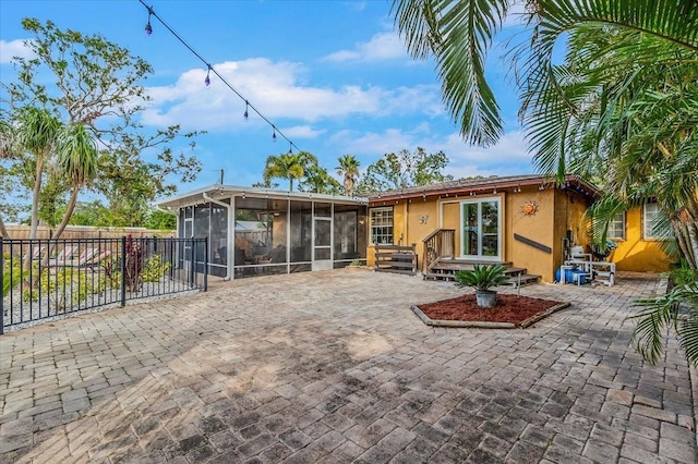 4301 S Lockwood Ridge Rd, Sarasota, FL 34231 - back of house with a sunroom, stucco siding, and a patio