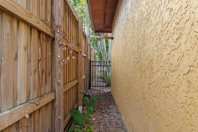 4301 S Lockwood Ridge Rd, Sarasota, FL 34231 - view of property exterior with stucco siding and a gate