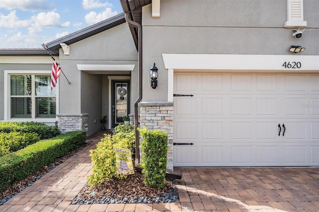 4620 Ballast Crest Cv, Land O Lakes, FL 34638 - doorway to property featuring stone siding, stucco siding, driveway, and a security system