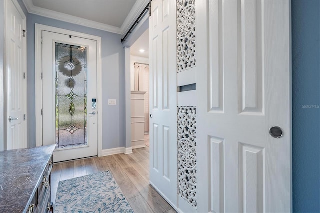 4620 Ballast Crest Cv, Land O Lakes, FL 34638 - foyer entrance with light wood-style flooring, ornamental molding, and a barn door