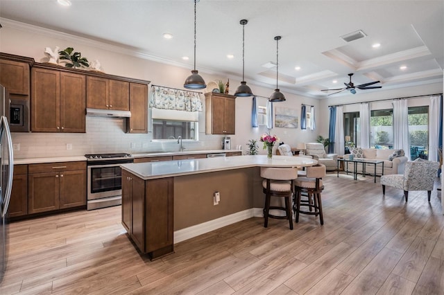 4620 Ballast Crest Cv, Land O Lakes, FL 34638 - kitchen featuring appliances with stainless steel finishes, under cabinet range hood, open floor plan, a center island, and light countertops