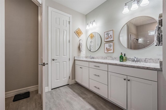 4620 Ballast Crest Cv, Land O Lakes, FL 34638 - bathroom featuring double vanity, wood finished floors, and tiled shower