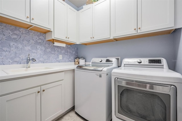 4620 Ballast Crest Cv, Land O Lakes, FL 34638 - laundry room featuring independent washer and dryer, wallpapered walls, and cabinet space