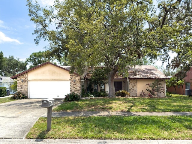1228 Rainbrook Cir, Valrico, FL 33596 - view of property hidden behind natural elements with driveway, an attached garage, brick siding, and a front lawn