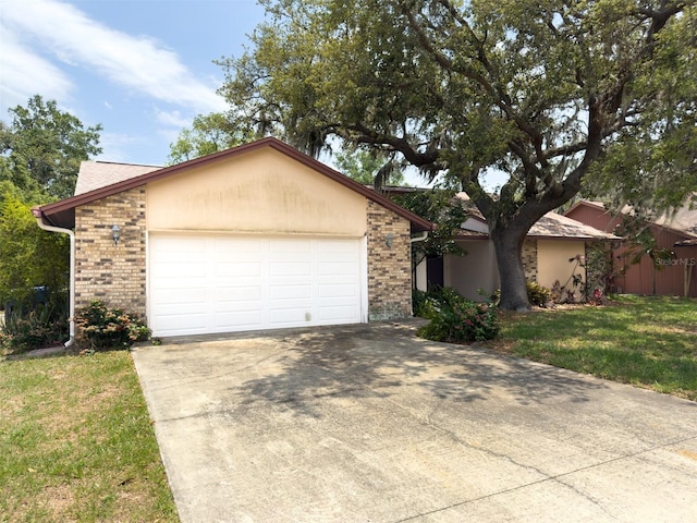 1228 Rainbrook Cir, Valrico, FL 33596 - view of front of home featuring brick siding, a garage, driveway, and a front lawn