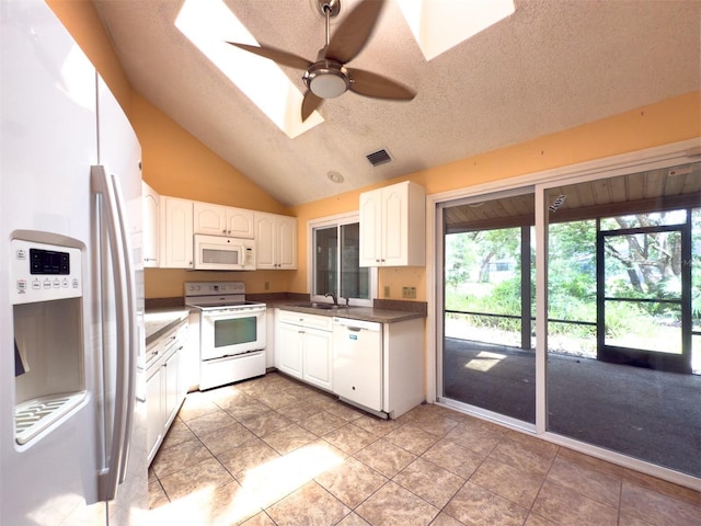 1228 Rainbrook Cir, Valrico, FL 33596 - kitchen with white appliances, a skylight, a sink, a ceiling fan, and lofted ceiling