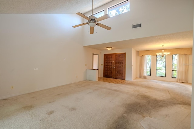 1228 Rainbrook Cir, Valrico, FL 33596 - unfurnished living room with light colored carpet, healthy amount of natural light, high vaulted ceiling, a chandelier, and a ceiling fan