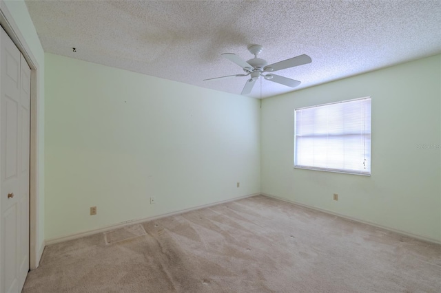 1228 Rainbrook Cir, Valrico, FL 33596 - unfurnished bedroom with carpet, a closet, a textured ceiling, and ceiling fan