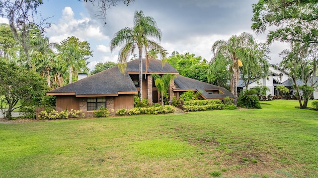 707 Warren Rd, Lutz, FL 33548 - view of front of house with a front yard and a chimney