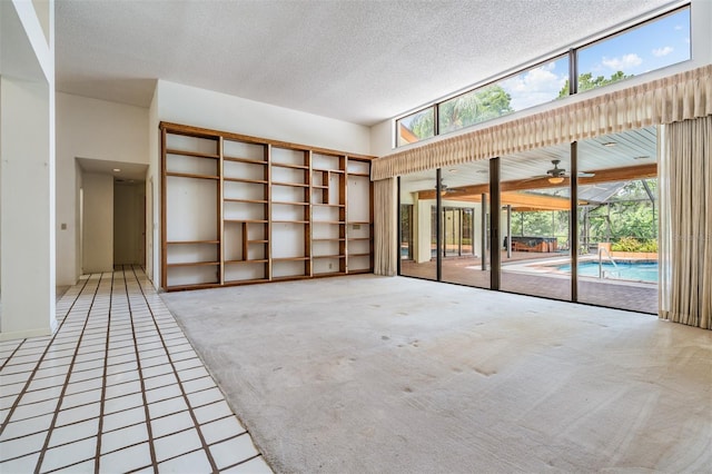 707 Warren Rd, Lutz, FL 33548 - spare room featuring plenty of natural light, light carpet, a textured ceiling, and a ceiling fan