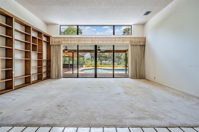 707 Warren Rd, Lutz, FL 33548 - carpeted spare room with a textured ceiling, healthy amount of natural light, and ceiling fan