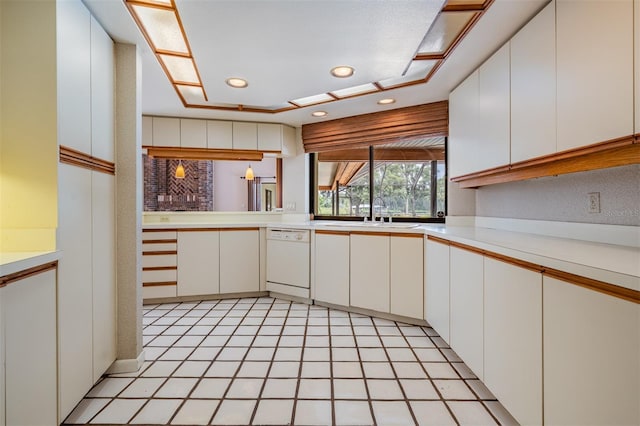 707 Warren Rd, Lutz, FL 33548 - kitchen with white dishwasher, light countertops, a sink, white cabinets, and recessed lighting