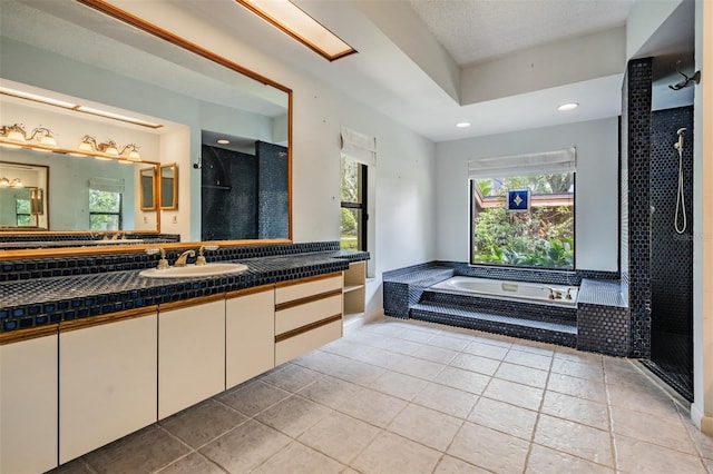 707 Warren Rd, Lutz, FL 33548 - bathroom with a tile shower, a bath, vanity, recessed lighting, and tile patterned floors
