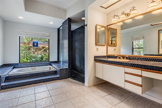 707 Warren Rd, Lutz, FL 33548 - bathroom featuring healthy amount of natural light, a garden tub, vanity, tile patterned flooring, and recessed lighting