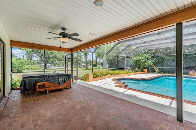 707 Warren Rd, Lutz, FL 33548 - outdoor pool with a hot tub, a patio area, ceiling fan, and glass enclosure