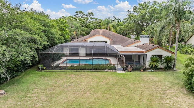 707 Warren Rd, Lutz, FL 33548 - back of property featuring an outdoor pool, glass enclosure, a lawn, and a patio
