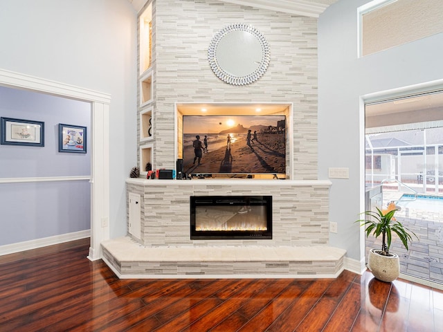 382 Florian Way, Spring Hill, FL 34609 - living area with wood finished floors, baseboards, a tile fireplace, and a high ceiling
