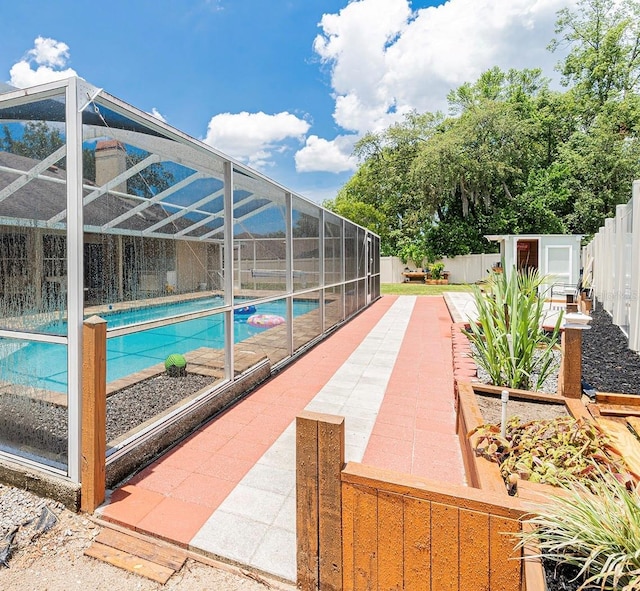 382 Florian Way, Spring Hill, FL 34609 - view of swimming pool featuring a fenced backyard, glass enclosure, a patio, and a garden
