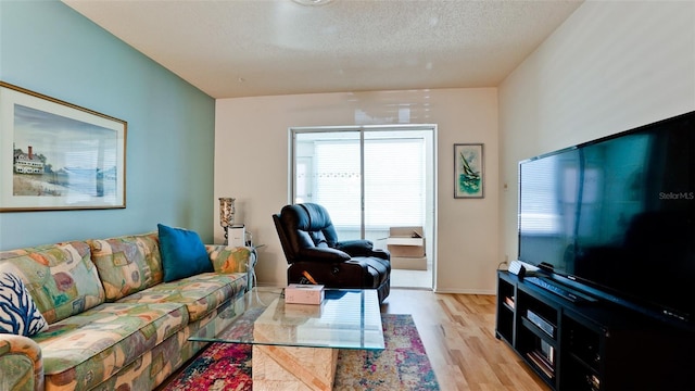 3534 Lake Bayshore Dr Unit 118, Bradenton, FL 34205 - living room featuring light wood-type flooring and a textured ceiling