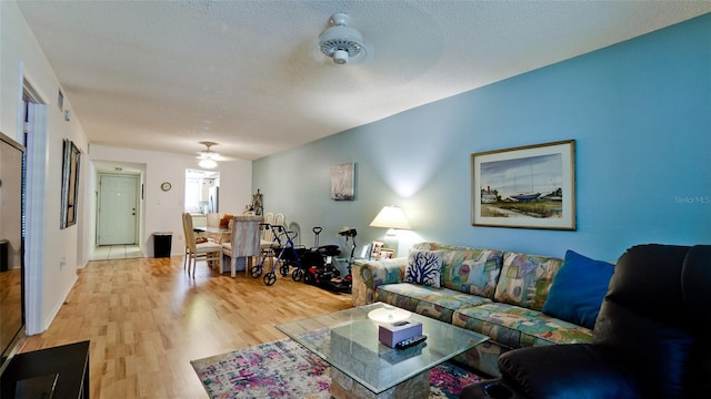 3534 Lake Bayshore Dr Unit 118, Bradenton, FL 34205 - living area with wood finished floors, a ceiling fan, and a textured ceiling