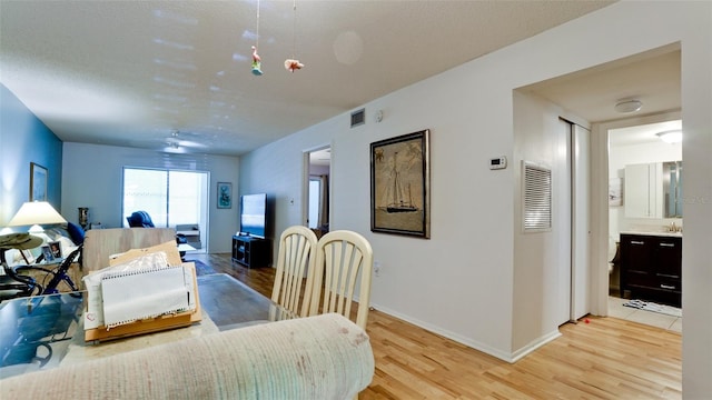 3534 Lake Bayshore Dr Unit 118, Bradenton, FL 34205 - dining area featuring light wood finished floors and baseboards