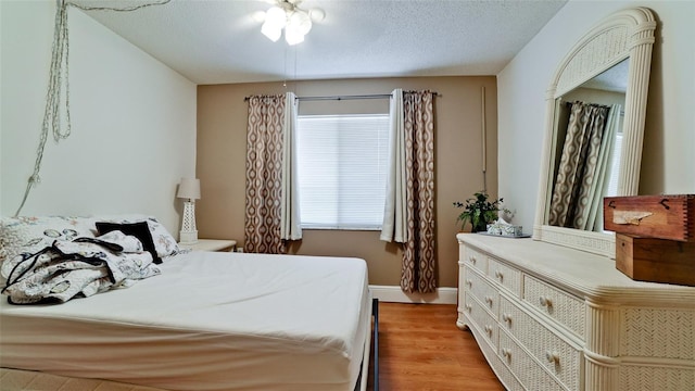 3534 Lake Bayshore Dr Unit 118, Bradenton, FL 34205 - bedroom featuring wood finished floors, baseboards, and a textured ceiling