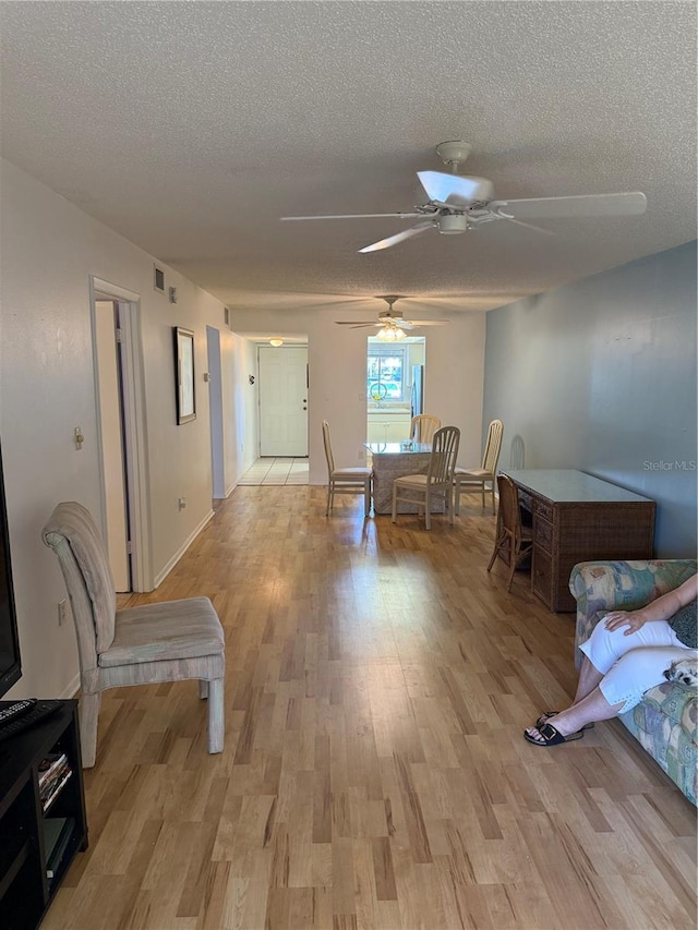 3534 Lake Bayshore Dr Unit 118, Bradenton, FL 34205 - hallway featuring light wood-style flooring and a textured ceiling