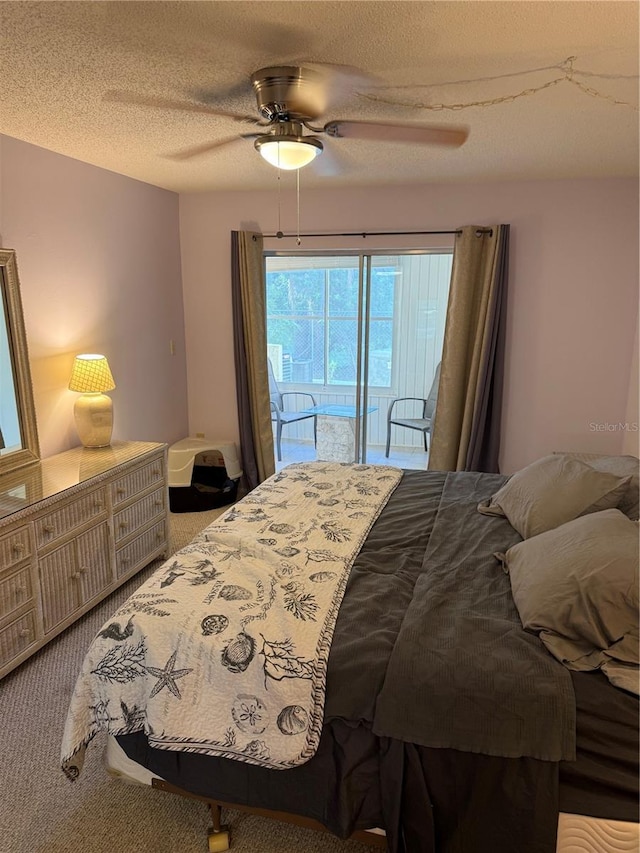 3534 Lake Bayshore Dr Unit 118, Bradenton, FL 34205 - bedroom featuring carpet, access to exterior, a ceiling fan, and a textured ceiling