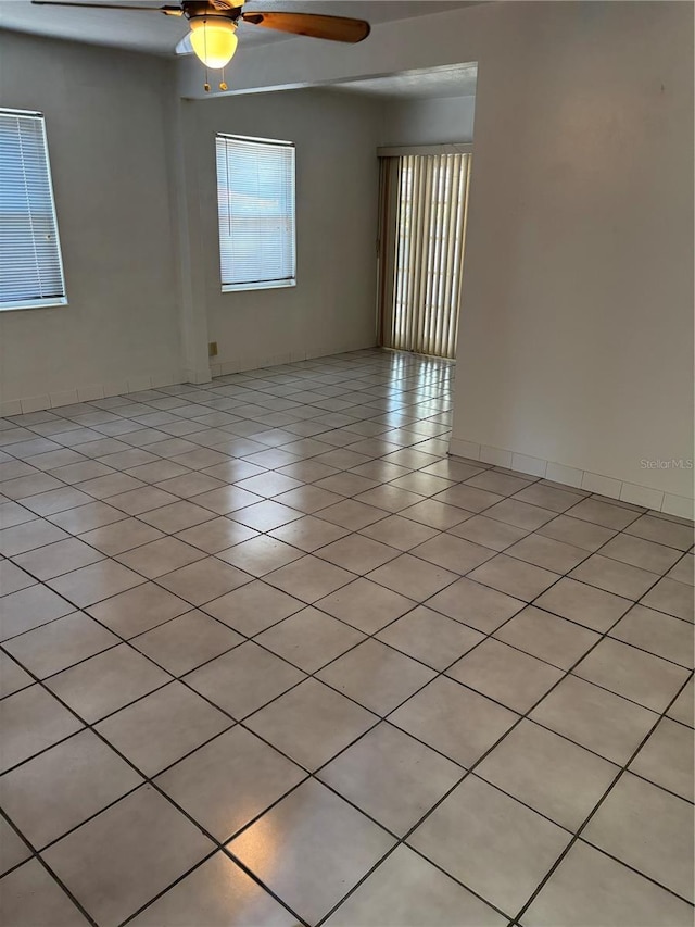 5008 N Suwanee Ave, Tampa, FL 33603 - empty room with a ceiling fan and light tile patterned floors