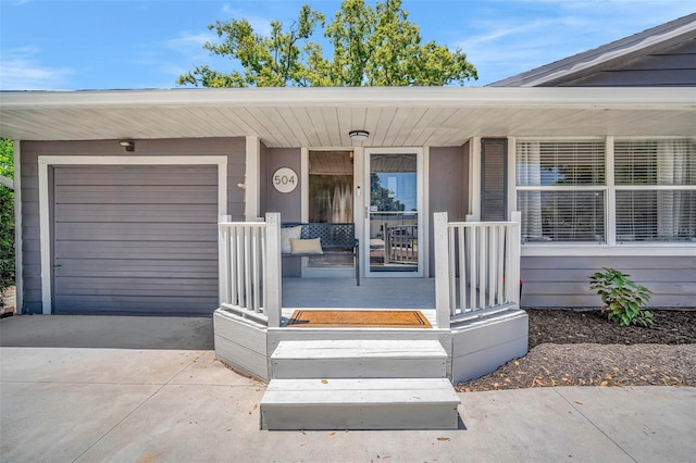 504 7th Ave SW, Largo, FL 33770 - entrance to property featuring a porch, driveway, and an attached garage