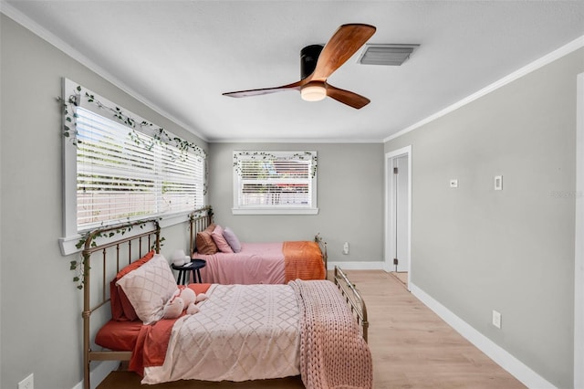 504 7th Ave SW, Largo, FL 33770 - bedroom featuring ornamental molding, light wood finished floors, baseboards, and a ceiling fan